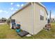 Tan mobile home with carport, landscaping, and storage at 1106 49Th Avenue W Dr, Bradenton, FL 34207