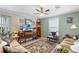 Bright living room with large windows, comfortable seating, and a ceiling fan at 1106 49Th Avenue W Dr, Bradenton, FL 34207