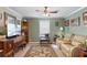 Spacious living room with a ceiling fan, large TV, and comfortable seating at 1106 49Th Avenue W Dr, Bradenton, FL 34207