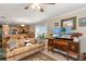 Living room features a comfy couch, antique wood cabinet, and a large TV at 1106 49Th Avenue W Dr, Bradenton, FL 34207