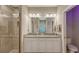 Modern bathroom with dual sinks, granite countertops, and a shower at 12413 Osorio Ct # 103, Sarasota, FL 34238