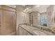 Double vanity bathroom with granite countertops and a walk-in shower at 12413 Osorio Ct # 103, Sarasota, FL 34238