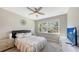 Spacious bedroom with a large window, ceiling fan, and ample closet space at 12413 Osorio Ct # 103, Sarasota, FL 34238