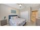 Well-lit bedroom with a queen bed, nightstands and access to laundry room at 12413 Osorio Ct # 103, Sarasota, FL 34238
