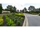 Gated community entrance with lush landscaping and a welcoming sign at 12413 Osorio Ct # 103, Sarasota, FL 34238
