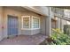 Condo entry with a dark blue door and a small window at 12413 Osorio Ct # 103, Sarasota, FL 34238
