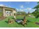 Community firepit with Adirondack chairs at 12413 Osorio Ct # 103, Sarasota, FL 34238