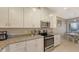 Modern kitchen with white cabinets and granite countertops at 12413 Osorio Ct # 103, Sarasota, FL 34238