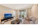 Bright living room with sliding glass doors leading to a patio and view of backyard at 12413 Osorio Ct # 103, Sarasota, FL 34238