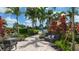 Seating area with lush tropical plants at 12413 Osorio Ct # 103, Sarasota, FL 34238