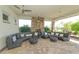 Spacious outdoor lounge with a fireplace and seating at 12413 Osorio Ct # 103, Sarasota, FL 34238