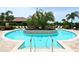 Community pool with surrounding lounge chairs at 12413 Osorio Ct # 103, Sarasota, FL 34238