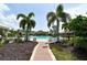 Resort-style pool with lounge chairs and palm trees at 12413 Osorio Ct # 103, Sarasota, FL 34238