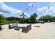 Outdoor sandy patio with fire pit and cornhole at 12413 Osorio Ct # 103, Sarasota, FL 34238