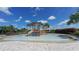 Community splash pad with a wooden play structure and slide at 12413 Osorio Ct # 103, Sarasota, FL 34238