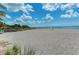 Scenic beach view with volleyball net, showcasing a relaxing atmosphere at 12651 Garibaldi Ln, Venice, FL 34293