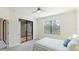 Cozy bedroom with neutral walls, plush carpet, and a view of the outdoors through large window and lanai access at 12651 Garibaldi Ln, Venice, FL 34293