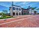 Attractive commercial space with outdoor seating, manicured landscaping, and brick road at 12651 Garibaldi Ln, Venice, FL 34293