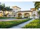 Gated community entrance with palm trees and a Mediterranean-style architecture at 12651 Garibaldi Ln, Venice, FL 34293