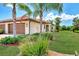 Well-maintained home with a two-car garage and lush landscaping at 12651 Garibaldi Ln, Venice, FL 34293