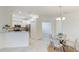 Modern kitchen with stainless steel appliances, white cabinets, and granite countertops next to dining area at 12651 Garibaldi Ln, Venice, FL 34293
