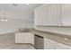 Modern kitchen with white cabinets and granite countertops at 12651 Garibaldi Ln, Venice, FL 34293