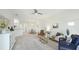 Open-concept living space with tile floors, comfortable seating, and seamless flow to the dining area at 12651 Garibaldi Ln, Venice, FL 34293