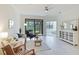 Bright living room featuring a comfortable sofa, stylish decor, and a seamless transition to the lanai at 12651 Garibaldi Ln, Venice, FL 34293