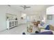 Bright and airy living space featuring tile floors, comfortable seating, and easy access to the dining area at 12651 Garibaldi Ln, Venice, FL 34293