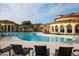 Resort-style community pool area with inviting lounge chairs and Mediterranean-inspired architecture at 12651 Garibaldi Ln, Venice, FL 34293