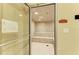 A bright community steam room has tile walls and floors plus built-in bench seating at 12651 Garibaldi Ln, Venice, FL 34293