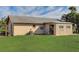 Back exterior showing additional structure and grassy yard at 13457 Muriel Ave, Port Charlotte, FL 33981
