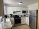 Bright kitchen featuring modern appliances and white cabinetry at 13457 Muriel Ave, Port Charlotte, FL 33981