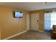 Living room with tiled floors and access to the front door at 13457 Muriel Ave, Port Charlotte, FL 33981