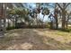 Large backyard with mature trees and wooden fence at 1376 18Th St, Sarasota, FL 34234