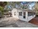 Side view of a cozy house with a screened porch and driveway at 1376 18Th St, Sarasota, FL 34234