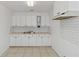 Bright kitchen features white cabinets, double sink, and tile backsplash at 1376 18Th St, Sarasota, FL 34234