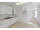 Bright kitchen features white cabinets, double sink, and tile backsplash at 1376 18Th St, Sarasota, FL 34234