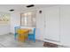 Bright screened porch with yellow table and blue chairs at 1376 18Th St, Sarasota, FL 34234
