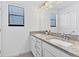 bathroom with double vanity and granite countertop at 15859 Islandwalk Ave, Bradenton, FL 34211