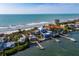 Aerial view of waterfront home with private dock, ocean access, and lush landscaping at 1620 Casey Key Rd, Nokomis, FL 34275