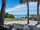 Landscaped backyard with lounge chairs and waterfront access at 1620 Casey Key Rd, Nokomis, FL 34275