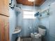 Small bathroom with walk-in shower and wood-paneled walls at 1620 Casey Key Rd, Nokomis, FL 34275