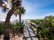 Private walkway to the beach with lush tropical landscaping at 1620 Casey Key Rd, Nokomis, FL 34275