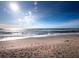 Expansive beachfront view with footprints in the sand at 1620 Casey Key Rd, Nokomis, FL 34275