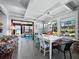 Casual dining area with white table and colorful chairs, overlooking the water at 1620 Casey Key Rd, Nokomis, FL 34275