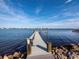 Private dock with boat lifts extending over calm water at 1620 Casey Key Rd, Nokomis, FL 34275