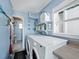 Bright laundry room with washer, dryer, and ample storage at 1620 Casey Key Rd, Nokomis, FL 34275