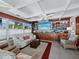 Relaxing living room featuring comfortable seating, built-in shelves, and ocean views at 1620 Casey Key Rd, Nokomis, FL 34275