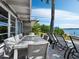 Outdoor patio with large table and chairs, offering waterfront view at 1620 Casey Key Rd, Nokomis, FL 34275